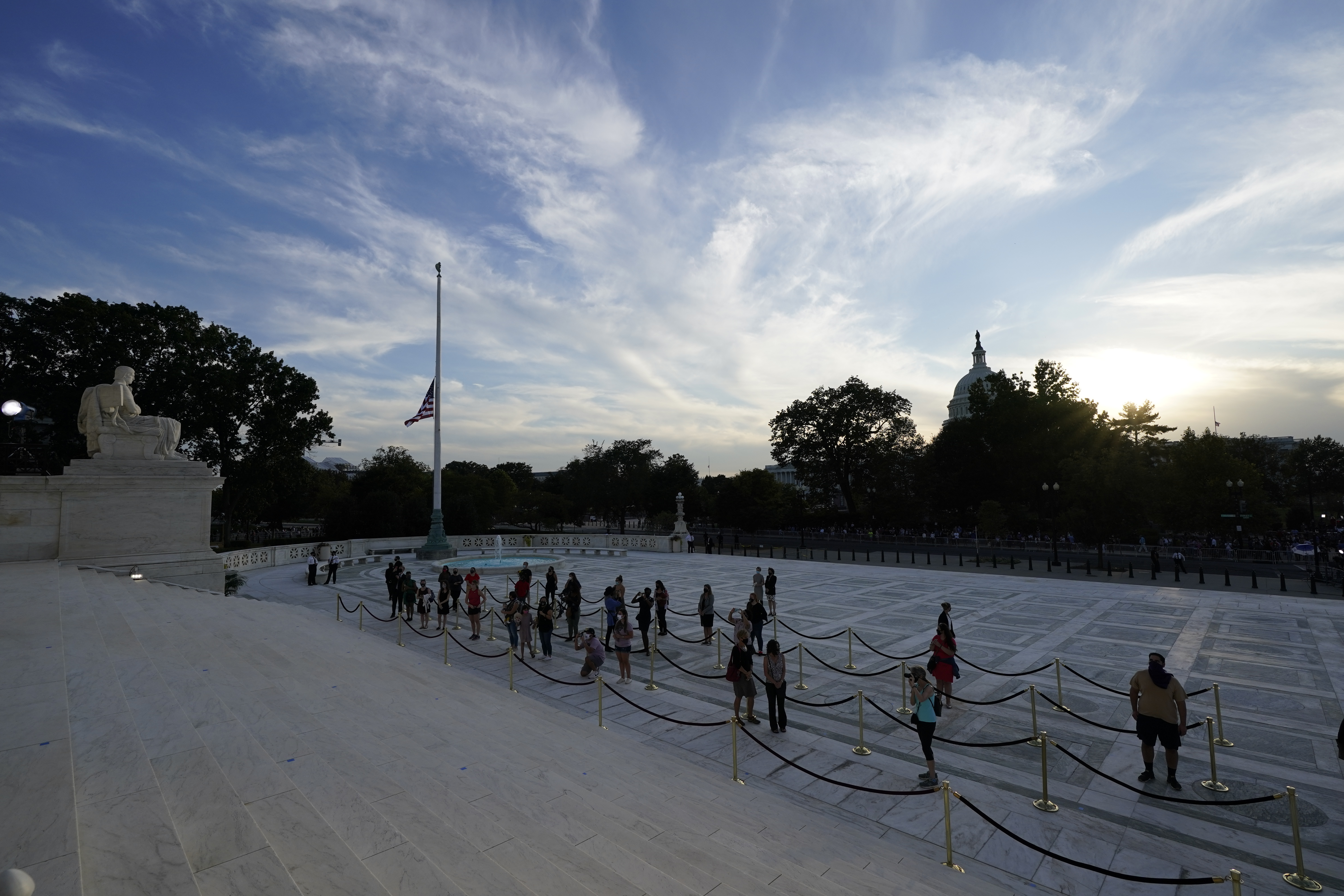 People pay respects as Justice Ruth Bader Ginsburg lies in repose under the Portico at the top of the front steps of the U.S. Supreme Court building on Wednesday, Sept. 23, 2020, in Washington. Ginsburg, 87, died of cancer on Sept. 18. (AP Photo/Andrew Harnik, Pool)