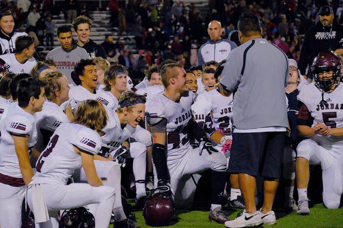 (Leah Hogsten  |  The Salt Lake Tribune) Jordan celebrates the win with head coach Kaleokalani Teriipaia.  Jordan High School boys' football team defeated Viewmont High School 28-20 during their class 5A football playoff opener, Friday, October 27, 2017 in Bountiful.