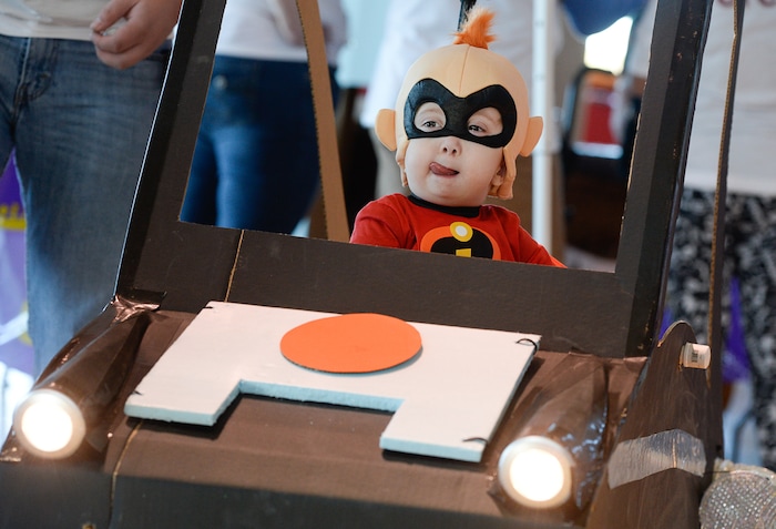 (Francisco Kjolseth  |  The Salt Lake Tribune)  Cooper Baskett, 3, assumes the role of Jack-Jack from the movie "The Incredibles" as an army of volunteers and staff at Shriners Hospital for Children in Salt Lake put the finishing touches on his Incredimobile and those of another 27 patients in wheelchairs for Halloween, Wednesday, Oct. 17, 2018.