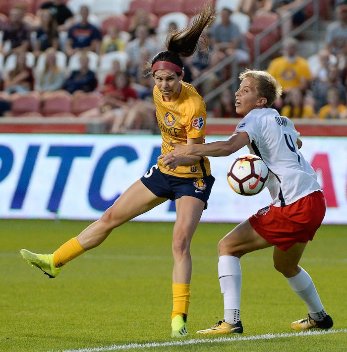 (Francisco Kjolseth  |  The Salt Lake Tribune)  Utah Royals FC hosts Washington Spirit, NWSL soccer at Rio Tinto Stadium in Sandy, Wed. Aug. 8, 2018. Utah Royals FC midfielder Erika Tymrak (15) tried to head one in to the goal past Washington Spirit defender Rebecca Quinn (4). 