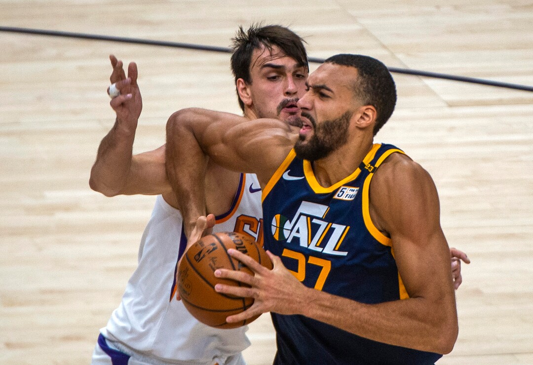 (Rick Egan | The Salt Lake Tribune) Utah Jazz center Rudy Gobert (27) goes to the hoop, as Phoenix Suns forward Dario Saric (20) defends, in NBA action between the Utah Jazz and the Phoenix Suns, on Thursday, Dec. 31, 2020.