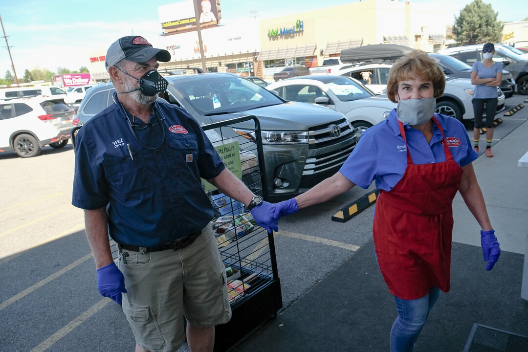 (Francisco Kjolseth  |  The Salt Lake Tribune) Snider Brothers Meats owners Will and Amy Wilson check in with one another at their store in Cottonwood Heights on Tuesday, May 5, 2020, as they open for the day to a steady stream of customers. Concerned over the well being of their staff they have been requiring that all customers wear masks or facial coverings when they come to shop. They say it's important to protect their employees, several of whom are the sole breadwinners in their families and have at-risk family members.