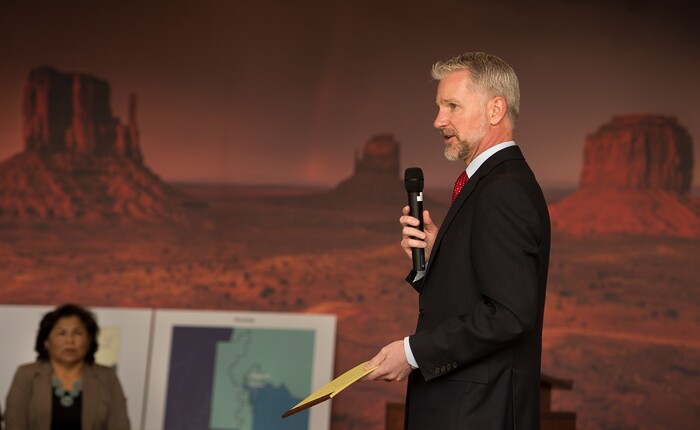 (Leah Hogsten  |  The Salt Lake Tribune) U.S. District Judge Robert Shelby gives details about how the redistricting process was determined to San Juan County residents attending the meeting in Monticello. At left is San Juan County Commissioner Rebecca Benally. The new boundaries would ensure significant American Indian majorities in two of three County Commission districts and on four of five school board voting districts as the result of a January 2012 lawsuit filed in U.S. District Court by the Navajo Nation. The lawsuit seeks the redrawing of voting districts to reflect the 2010 U.S. Census. Last year, Shelby ruled the voting districts in the sprawling southeastern Utah county, which today is home to 16,895 residents, are unconstitutional and violate the rights of American Indians. Shelby intends to accept new voting districts by December 15. 