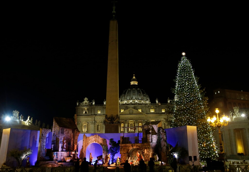 The 25.5 meters (83.66 ft), 70-year old Christmas tree and the Nativity scene are lit in St. Peter's square at the Vatican, Friday, Dec. 19, 2014. (AP Photo/Gregorio Borgia)