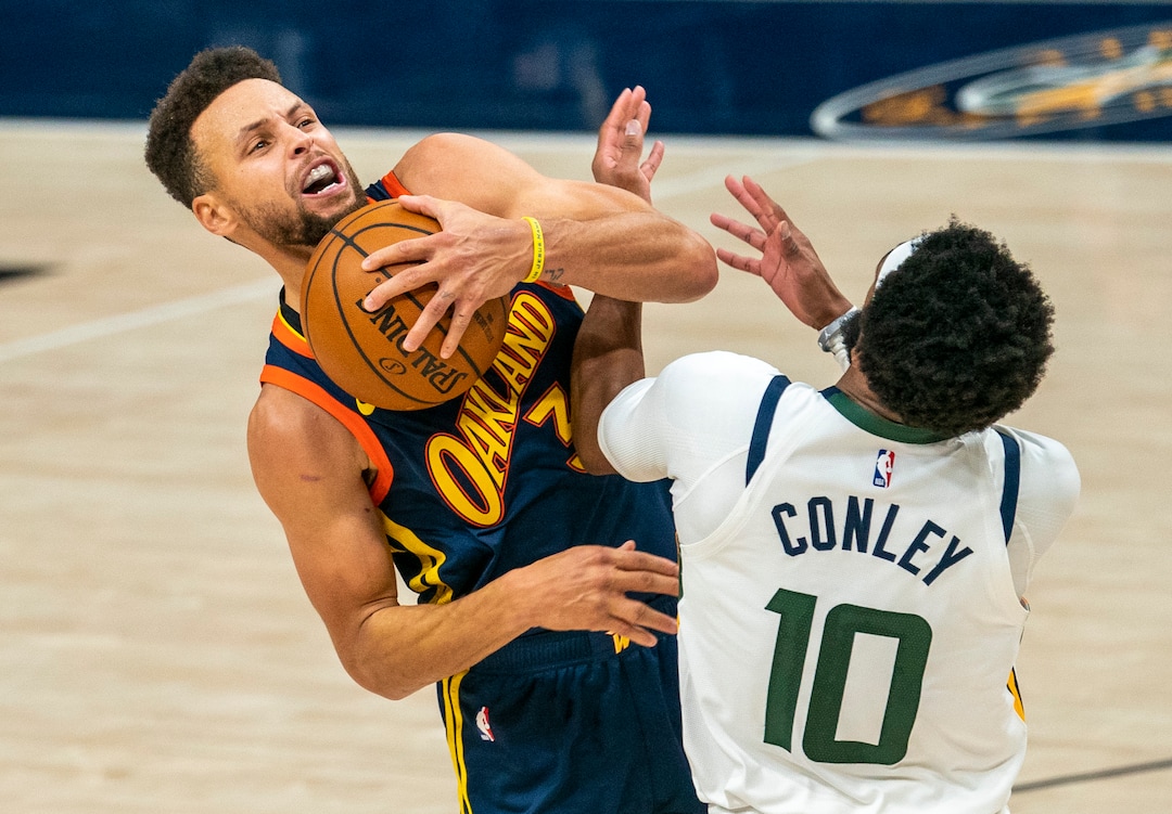 (Rick Egan | The Salt Lake Tribune) Golden State Warriors guard Stephen Curry (30) manages to score and draw a foul as he collides with Utah Jazz guard Mike Conley (10), in NBA action between the Utah Jazz and the Golden State Warriors at Vivint Arena, on  Saturday, Jan. 23, 2021.