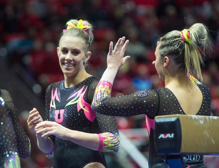 (Rick Egan  |  The Salt Lake Tribune)   Team mates congratulate MaKenna Merrell-Giles after her performance on the beam for Utah, in Gymnastics action Utah vs. Oregon State at the Jon M. Huntsman Center, Friday, January 19, 2018.
