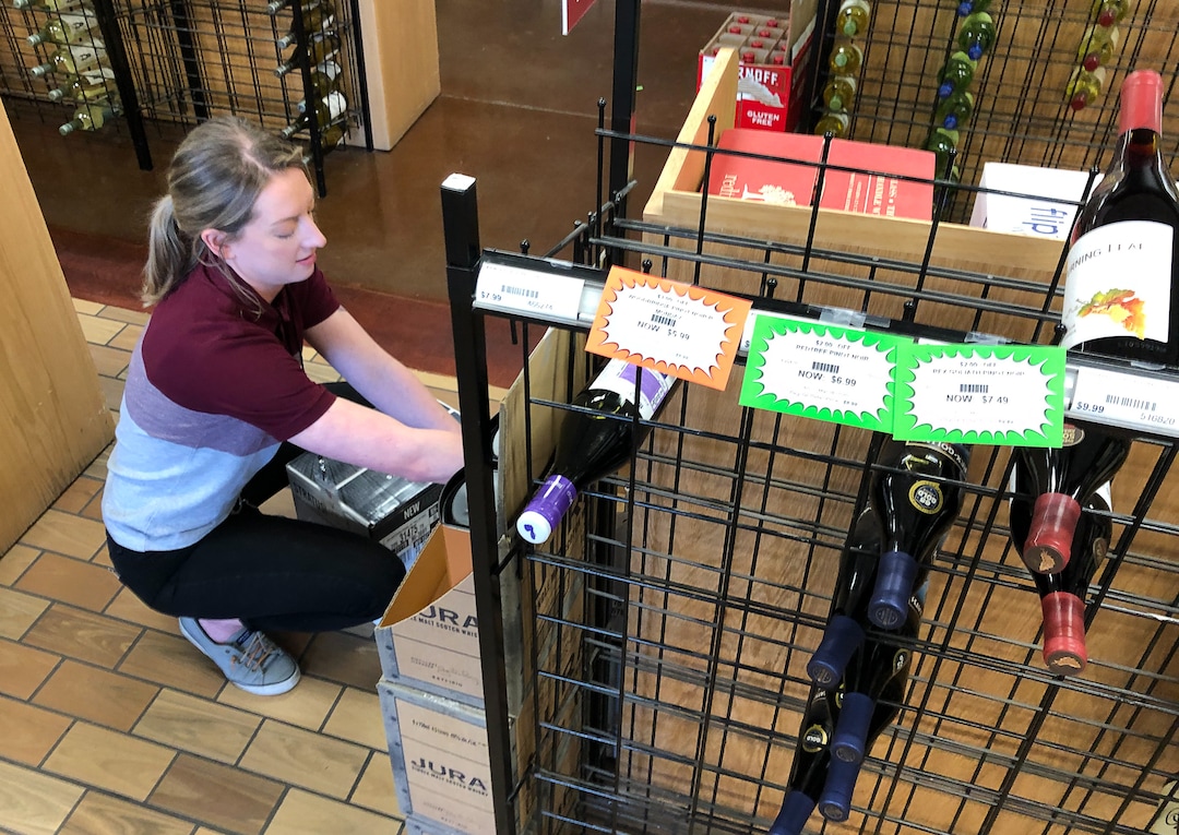 (Francisco Kjolseth  |  The Salt Lake Tribune) Liquor rep Sue Nielsen helps stock the racks at the state-run liquor store in Murray that has faced some empty shelves and long lines but staff continue to restock product on Tuesday, March 17, 2020. Before Utahns hunker down during the coronavirus, they are stocking up on wine, beer and spirits at state-run liquor stores. Last weekend, the state sold $8 million in alcohol Ñ a total that resembles the day before Thanksgiving or Christmas.