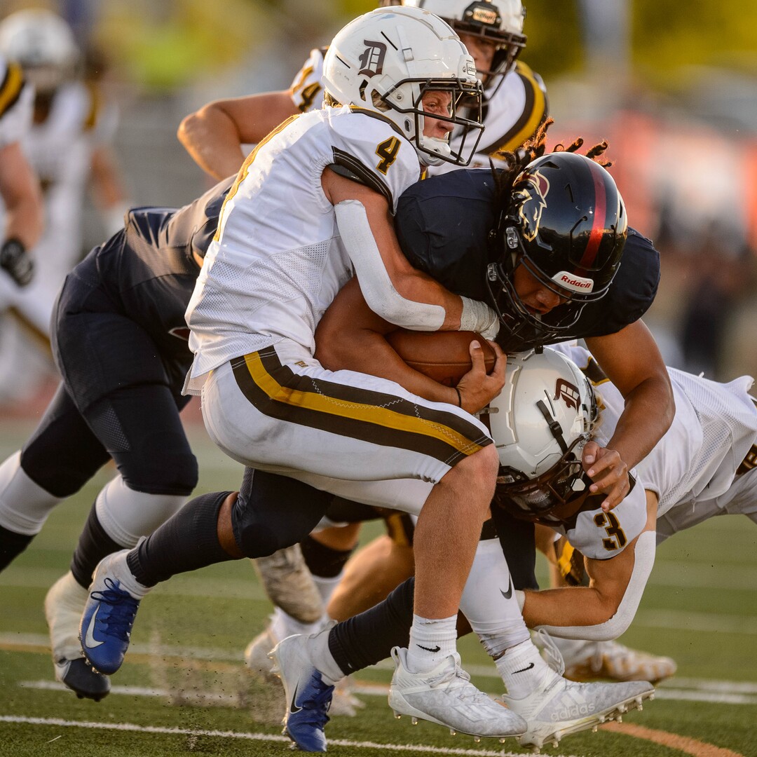 (Trent Nelson  |  The Salt Lake Tribune) Davis defenders bring down Herriman's Nu'u Tafisi as Herriman hosts Davis High School football, in Herriman on Thursday, Aug. 13, 2020.
