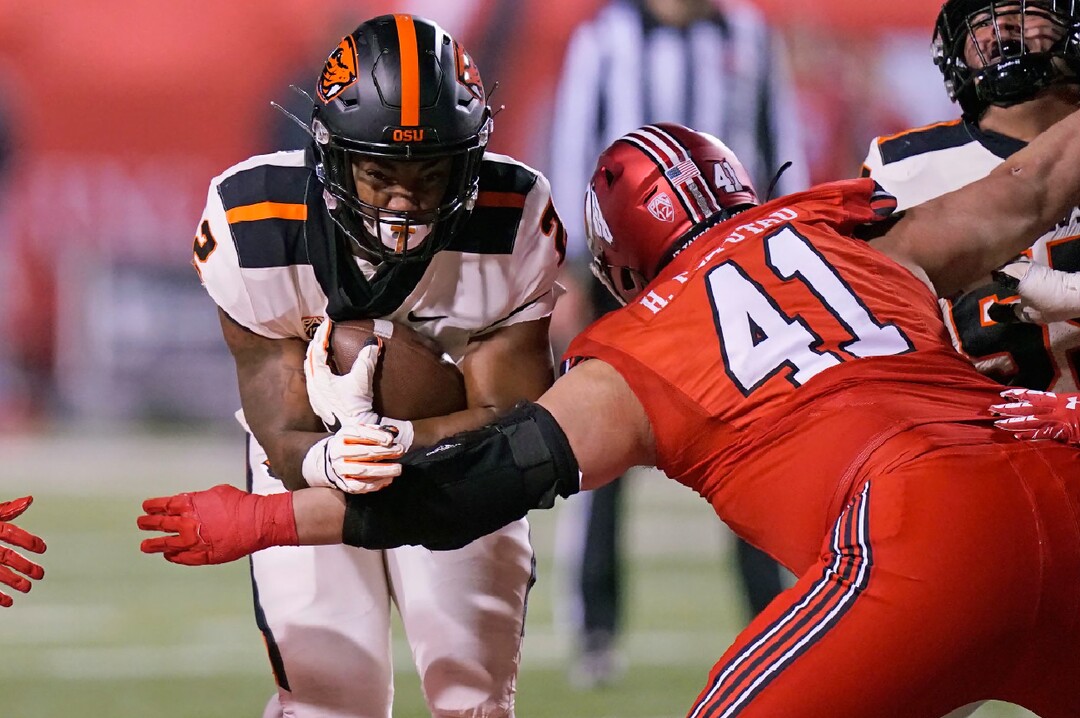 Utah defensive tackle Hauati Pututau (41) tackles Oregon State running back Calvin Tyler Jr. (2) during the first half of an NCAA college football game Saturday, Dec. 5, 2020, in Salt Lake City. (AP Photo/Rick Bowmer)