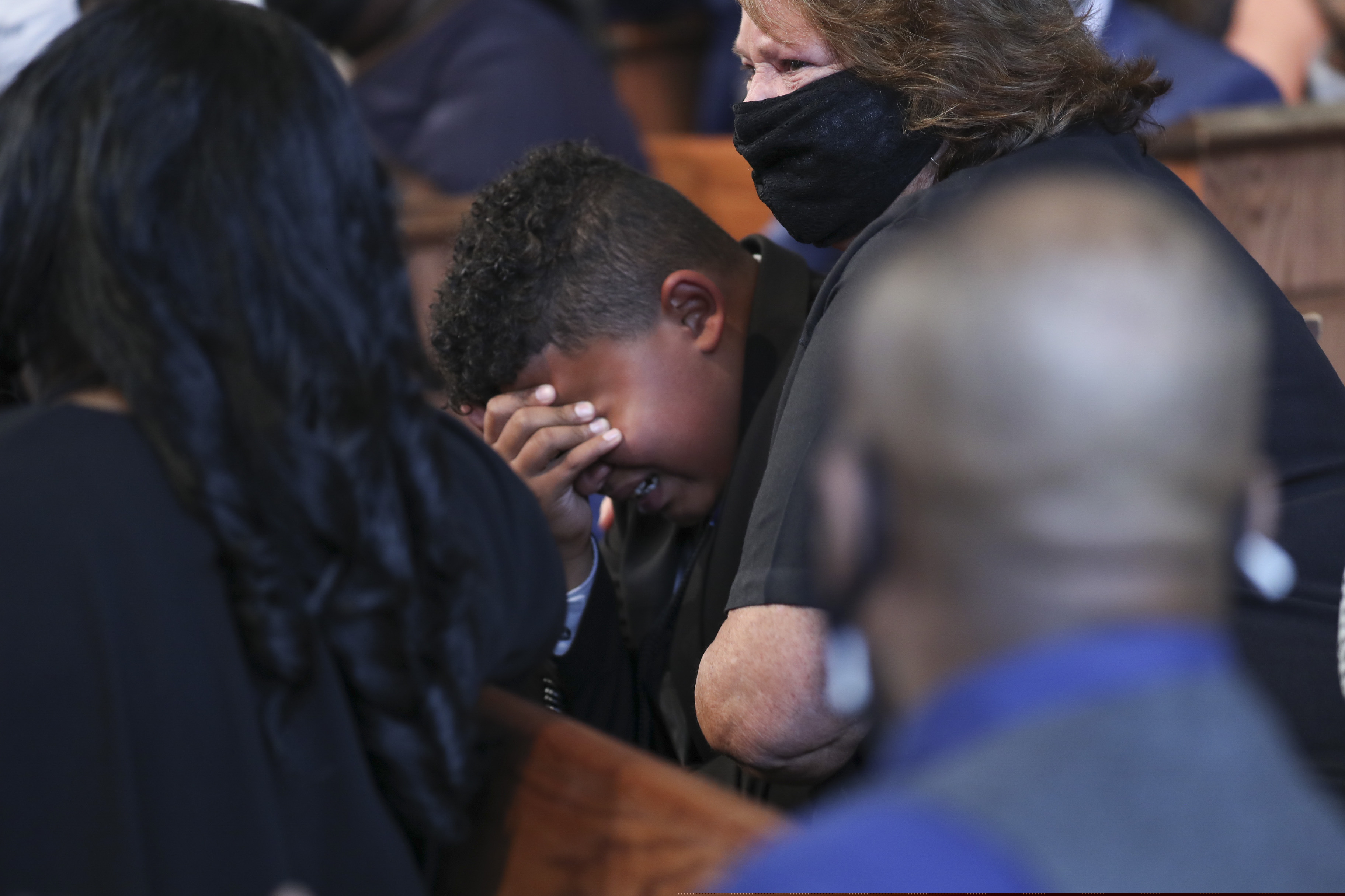 Tybre Faw becomes emotional after the reading of John Lewis' favorite poem, "Invictus" by William Ernest Henley during the funeral service for the late Rep. John Lewis, D-Ga., at Ebenezer Baptist Church in Atlanta, Thursday, July 30, 2020.  (Alyssa Pointer/Atlanta Journal-Constitution via AP, Pool)