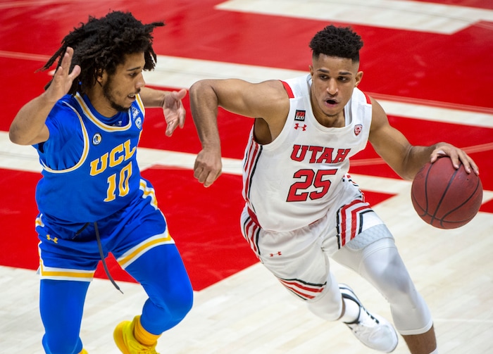 (Rick Egan | The Salt Lake Tribune)  Utah Utes guard Alfonso Plummer (25) takes the ball downcourt, as UCLA Bruins guard Tyger Campbell (10) defends, in PAC-12 basketball action at the Jon M. Huntsman Center, on Thursday, Feb. 25, 2021.