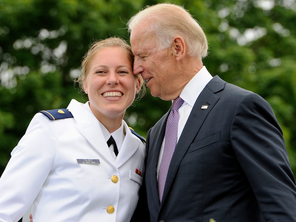 FILE - In this May 22, 2013 file photo, Newly commissioned officer Erin Talbot, left, poses for a photograph with Vice President Joe Biden during commencement for the United States Coast Guard Academy in New London, Conn. As former Vice President Biden's camp scrambles to contain any political damage over his past behavior with women, House Speaker Nancy Pelosi has some words of advice: Keep your distance. (AP Photo/Jessica Hill)