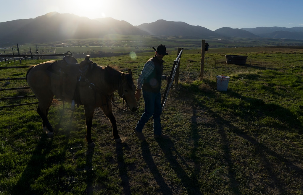 (Bethany Baker  |  The Salt Lake Tribune) Spencer Butterfield opens the gate to a pasture during a trail ride at Golden Hour Farm in Hyrum on Thursday, March 26, 2026.