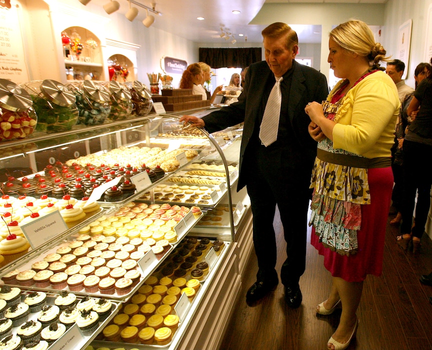 (Leah Hogsten  |  Salt Lake Tribune file photo)
The Sweet Tooth Fairy owner Megan Faulkner Brown, right, discusses cupcakes on June 11, 2010, with media mogul Sumner Redstone, owner of media companies including CBS and Viacom, at the opening of Brown's location in Salt Lake City's Foothill Village. The location is scheduled to close in July 2024, according to a sign on the bakery's door.