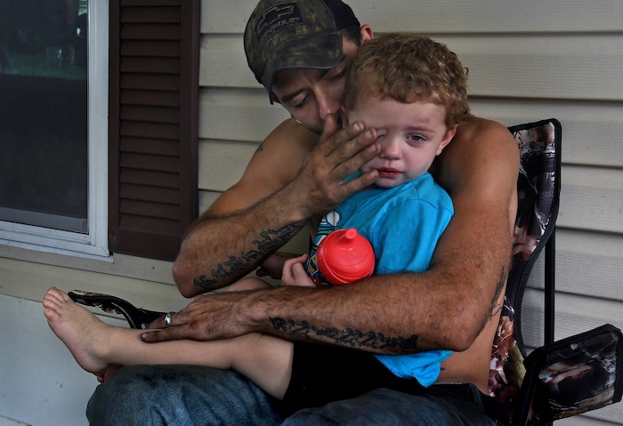(Washington Post photo by Michael S. Williamson) Phil Manning wipes tears from Douglas's eye after he ran into a door. Phil says that he really loves Douglas, whom Maria had during a previous relationship, and wants to raise him as his own.