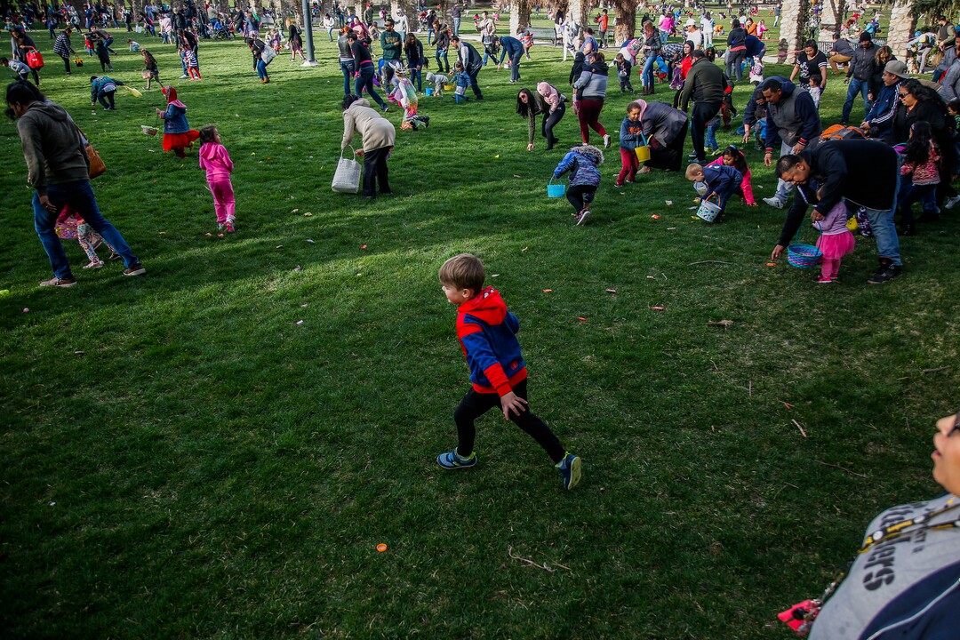 (Nicole Boliaux  |  For The Tribune)  Children and their families run to grab Easter eggs during the annual Easter egg hunt put on by A Kid's Place Dentistry in Liberty Park in Salt Lake City on Saturday, March 31, 2018.