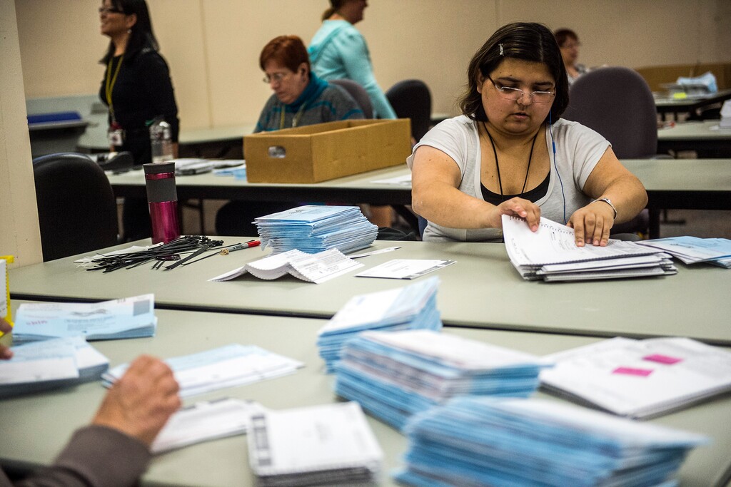 (Chris Detrick  |  The Salt Lake Tribune)  Jan Young opens and prepares ballots for tabulation at the Salt Lake County Government Center on Wednesday, Nov. 4, 2015.