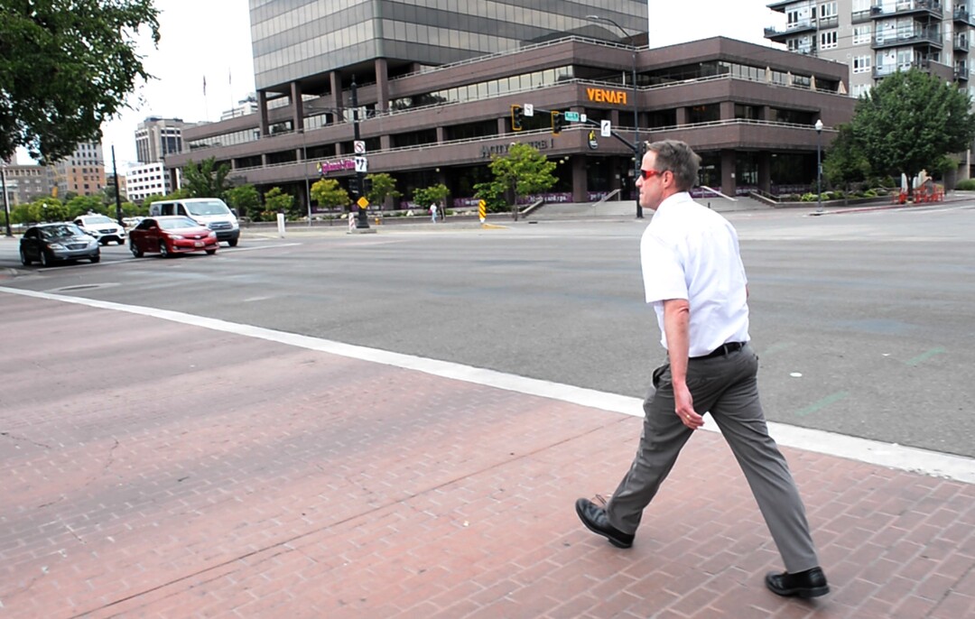 (Rick Egan  |  The Salt Lake Tribune)       Salt Lake Tribune editor Dave Noyce crosses 200 East at the start of a race against colleagues after using his own two feet in a transportation race from Library Square to the Tribune building at the Gateway on Thursday, Aug. 2, 2018. 