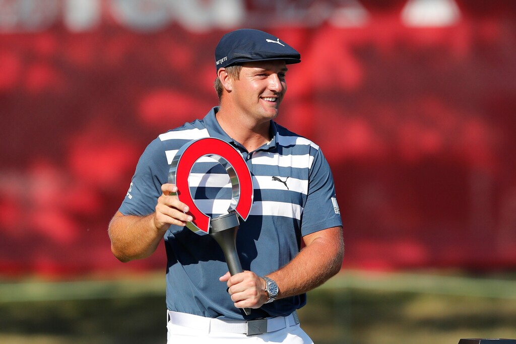 Bryson DeChambeau holds the Rocket Mortgage Classic golf tournament trophy Sunday, July 5, 2020, at Detroit Golf Club in Detroit. DeChambeau won the tournament by three strokes for his first victory of the season and sixth overall. (AP Photo/Carlos Osorio)