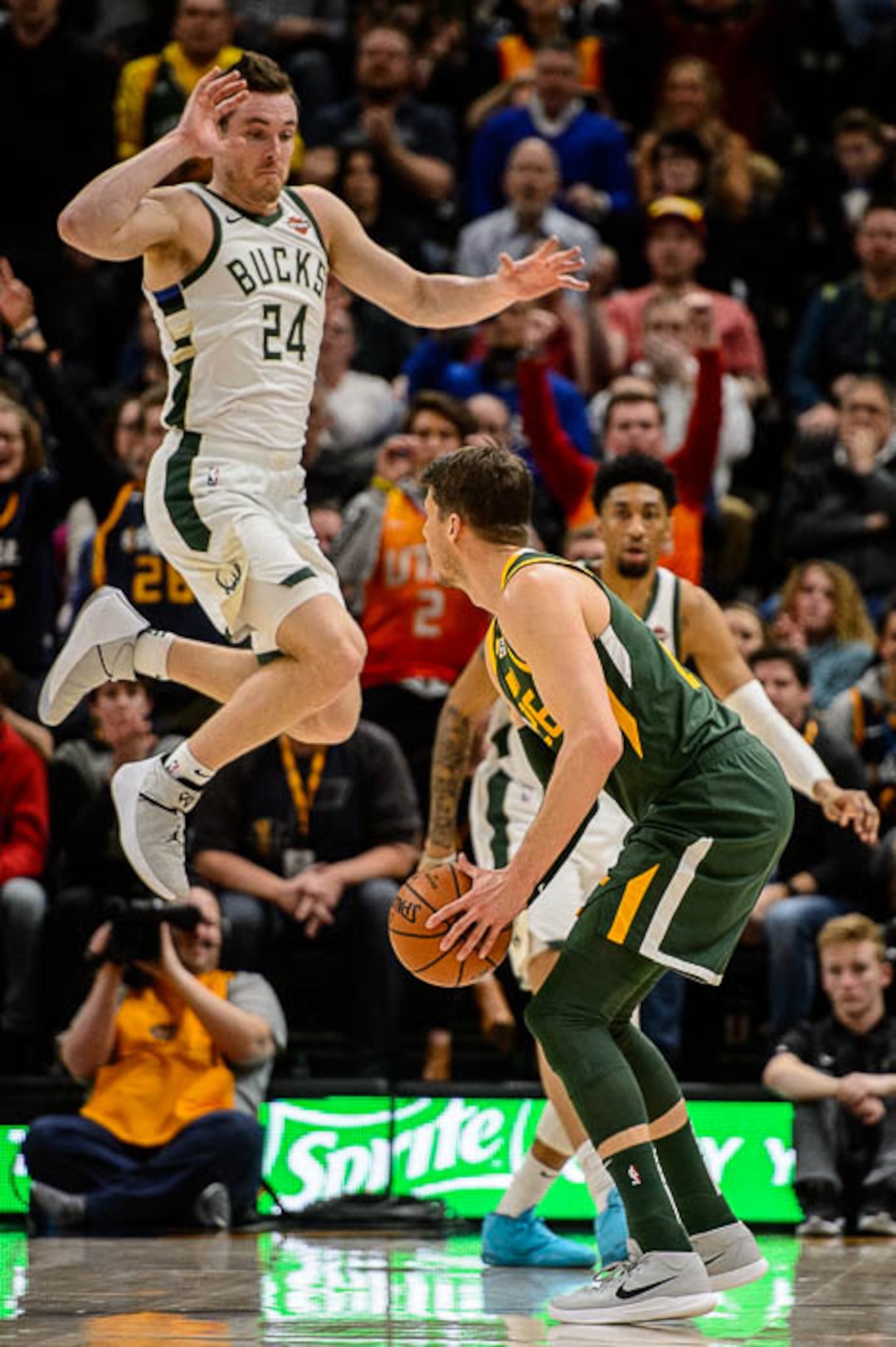(Trent Nelson | The Salt Lake Tribune)  Milwaukee Bucks guard Pat Connaughton (24) leaps up to defend Utah Jazz guard Kyle Korver (26), who pauses and hits the three-pointer as the Utah Jazz host the Milwaukee Bucks, NBA basketball in Salt Lake City on Saturday March 2, 2019.