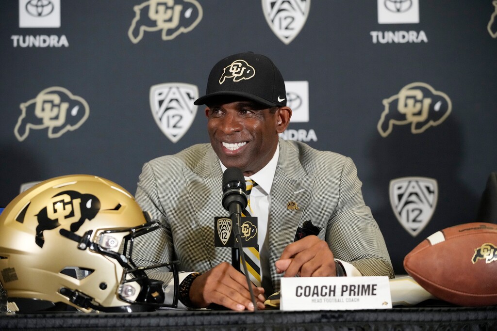 (David Zalubowski | AP) Deion Sanders speaks after being introduced as the head football coach at the University of Colorado during a news conference Sunday, Dec. 4, 2022, in Boulder, Colo.
