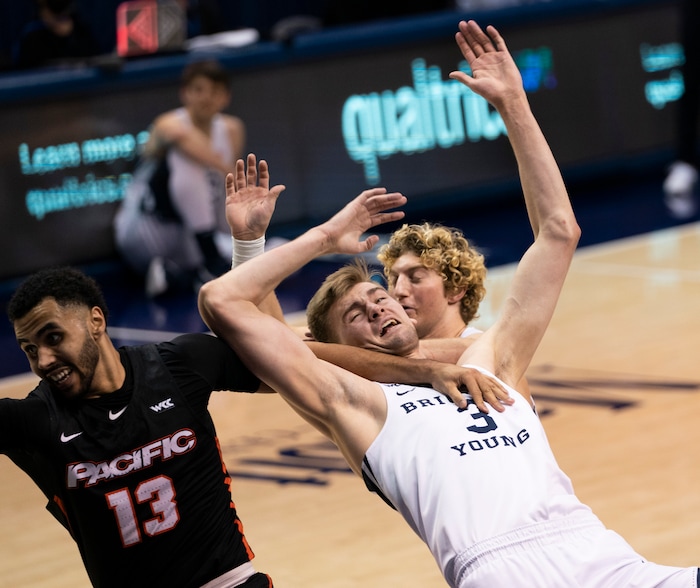 (Rick Egan | The Salt Lake Tribune)  Brigham Young Cougars forward Matt Haarms (3) gets tangled up with Pacific Tigers forward Jeremiah Bailey (13), in basketball action, between the Brigham Young Cougars and the Pacific Tigers, at the Marriott Center in Provo, on Saturday, Jan. 30, 2021.