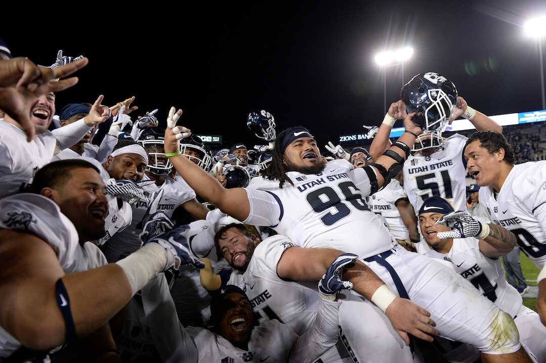 Leah Hogsten  |  The Salt Lake Tribune   Utah State Aggies celebrate the win after defeating BYU, 45-20, at Lavell Edwards Stadium in Provo, Friday, Oct. 5, 2018.