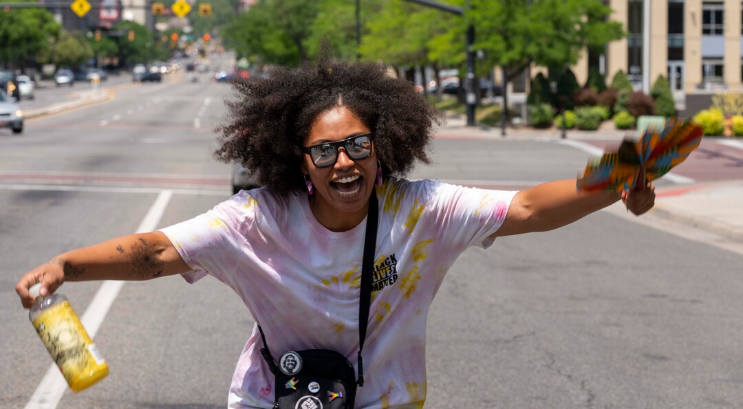 (Rick Egan | The Salt Lake Tribune)  Rae Duckworth, dances to the music as Junteenth revelers march down State Street, in Salt Lake City, during the Juneteenth celebration, on  Saturday, June 19, 2021.
