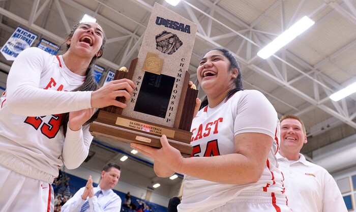 (Leah Hogsten  |  The Salt Lake Tribune) East's Liana KaituÕu (23) and East's Lani Taliauli (54) accept the championship trophy.  East defeated Timpview 68-48 to win the the 5A High School Girls' Basketball Tournament title at SLCC in Taylorsville, Saturday, Feb. 24, 2018. 