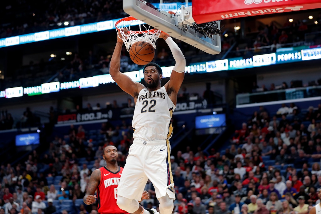 New Orleans Pelicans forward Derrick Favors (22) slam dunks in front of Houston Rockets forward Gary Clark in the second half of an NBA basketball game in New Orleans, Sunday, Dec. 29, 2019. The Pelicans won 127-112. (AP Photo/Gerald Herbert)