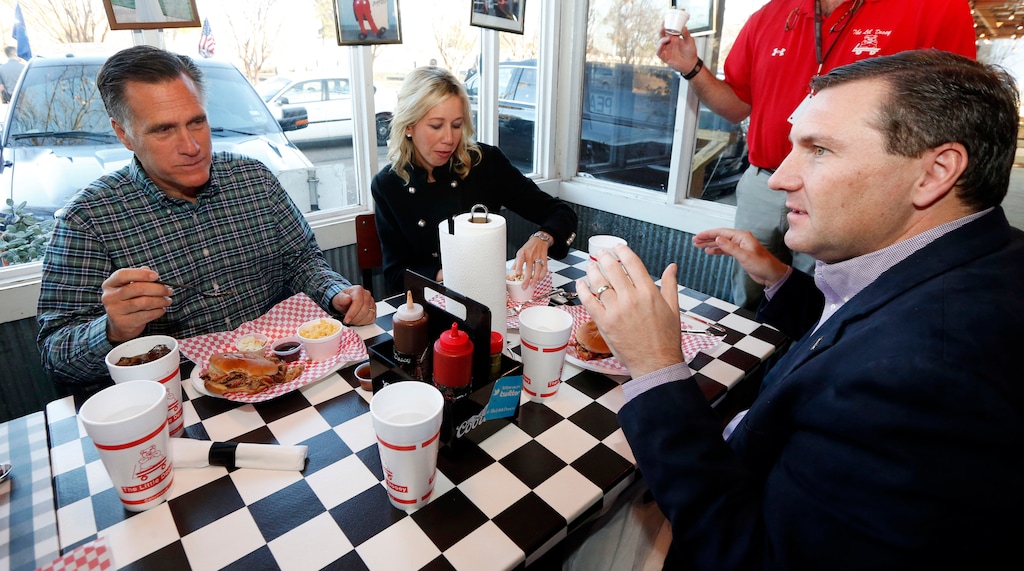 (The Associated Press | Rogelio V. Solis) 
Former Massachusetts Gov. Mitt Romney, left, eats dinner at a barbecue restaurant with Megan Mullen, wife of Mississippi State football coach Dan Mullen, and Dan Mullen, right, in 2015. 
A report about his favorite meats did not mention where brisket factors into his preferences