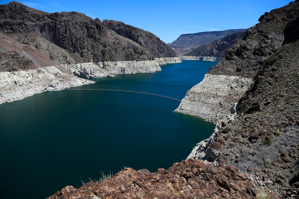 (Ross D. Franklin | The Associated Press) This May 31, 2018 file photo shows the reduced water level of Lake Mead behind Hoover Dam in Arizona. Several states that rely on a major Western river are pushing for federal legislation to implement a plan to keep key reservoirs from shrinking amid a prolonged drought. The Colorado River serves 40 million people in Arizona, California, Colorado, Nevada, New Mexico, Utah and Wyoming. Representatives from those states are meeting Tuesday, March 19, 2019, to sign a letter to Congress asking for support for so-called drought contingency plans.