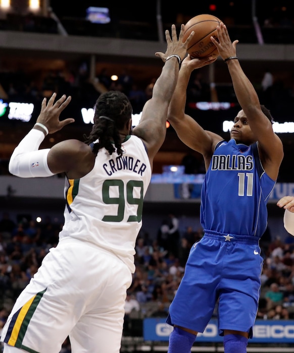 Utah Jazz forward Jae Crowder (99) defends against a shot by Dallas Mavericks guard Yogi Ferrell (11) during the first half of an NBA basketball game Thursday, March 22, 2018, in Dallas. (AP Photo/Tony Gutierrez)