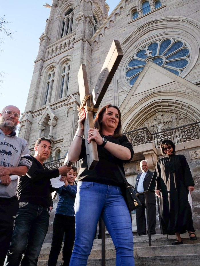 (Francisco Kjolseth  |  The Salt Lake Tribune)  Nawal Zaflow takes the first turn as christians march through streets of Salt Lake City on Good Friday to symbolically mark Jesus' carrying the cross to his crucifixion beginning at Cathedral of the Madeleine.