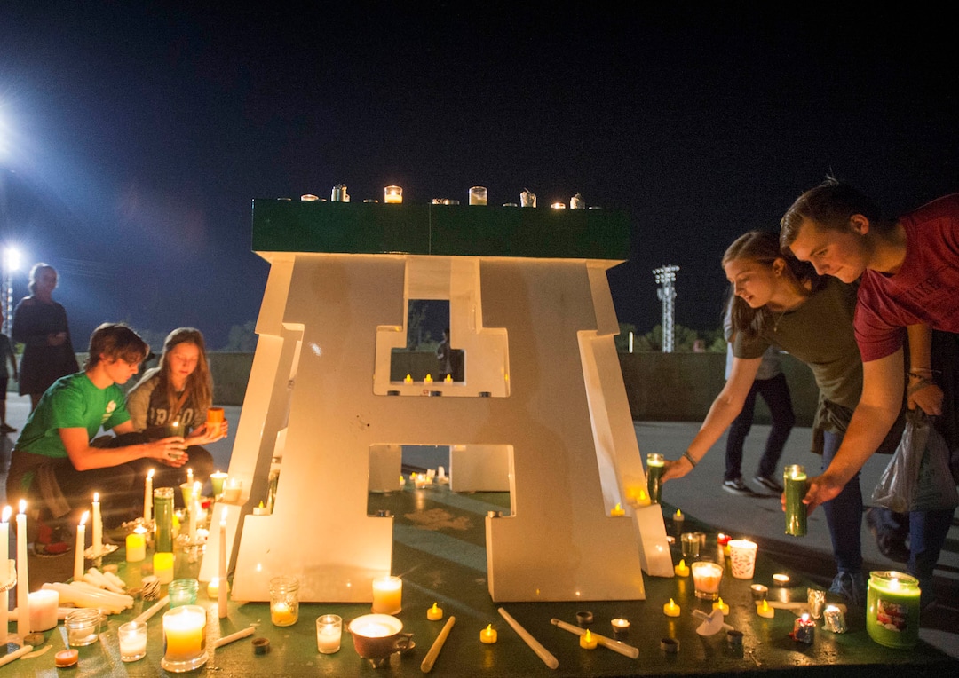 (Rick Egan  |  The Salt Lake Tribune)Hillcrest high students and supporters leave candles at the football field, during a candlelight vigil in honor of coach Cazzie Brown, at Hillcrest High School, Monday, August 28, 2017.