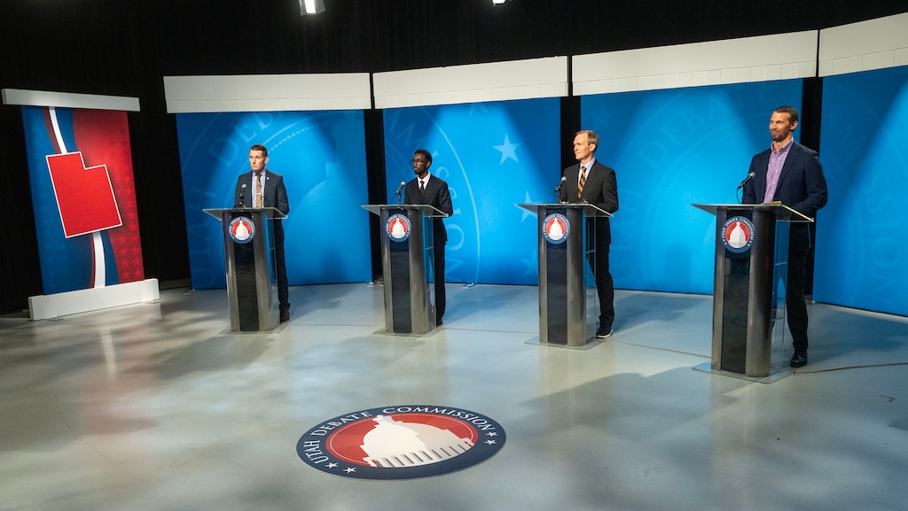 (Scott G Winterton | Pool) From left, candidates Nate Blouin, Liban Mohamed, Ben McAdams, and Michael Farrell face off in the 1st Congressional District Democratic primary debate in Salt Lake City on Wednesday, May 27, 2026.