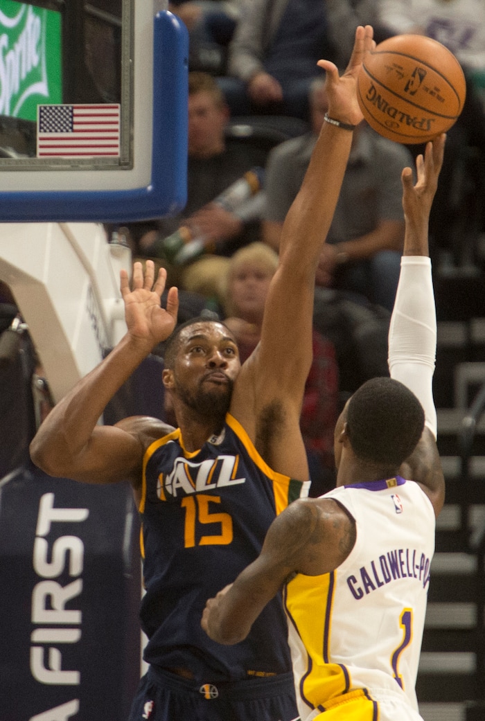 (Rick Egan  |  The Salt Lake Tribune)   Los Angeles Lakers guard Kentavious Caldwell-Pope (1) shoots over Utah Jazz forward Derrick Favors (15), in NBA action, Utah Jazz vs. Los Angeles Lakers, in Salt Lake City, Saturday, October 28, 2017.