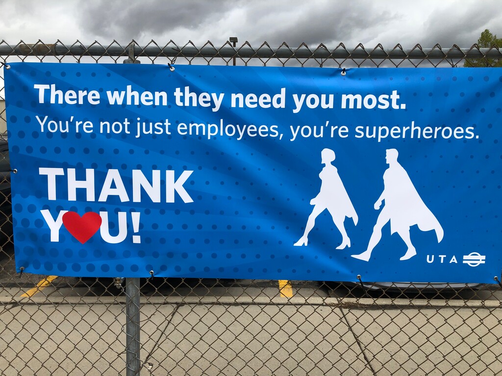 (Photo courtesy of Utah Transit Authority) A banner at UTA headquarters shows bus and train operators as superheroes serving the public during the coronavirus pandemic.