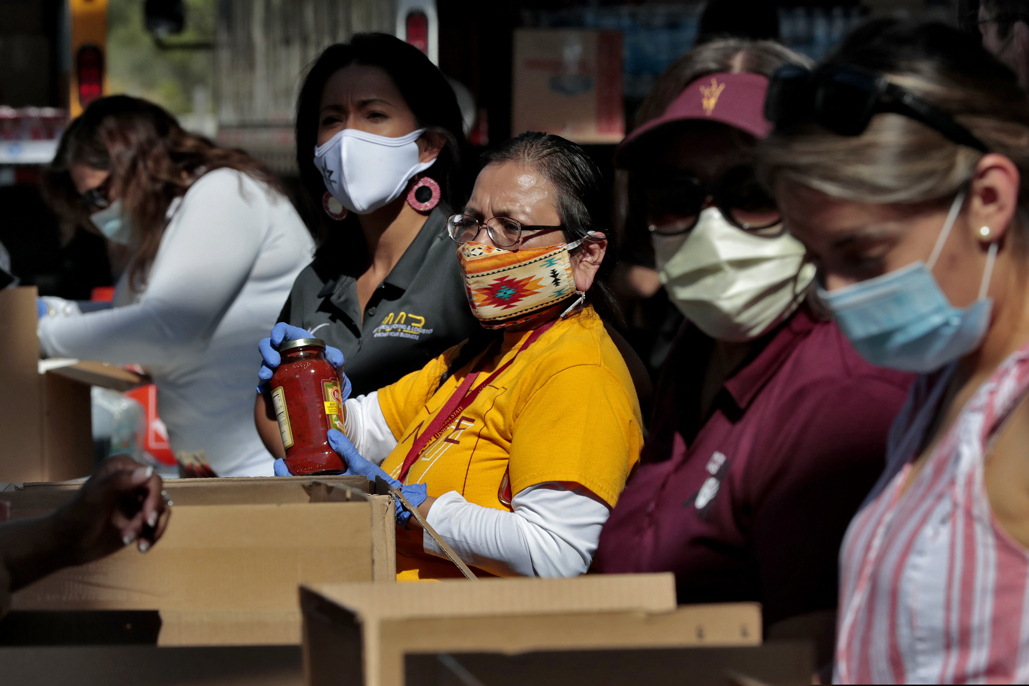 (Matt York | AP file photo)  Volunteers prepare donations for delivery to those affected by COVID-19 on tribal lands Thursday, June 25, 2020, in Tempe, Ariz. The resource drive is for families isolated due to COVID-19 on Navajo, Hualapai, Havasupai and White Mountain Apache tribal lands.