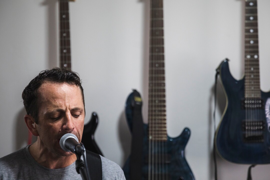 (Clark Clifford  |  For The Salt Lake Tribune) Bryce Taylor sings and plays guitar during a practice for an upcoming show in the band's rehearsal space in Orem on Saturday, Aug. 3, 2019.