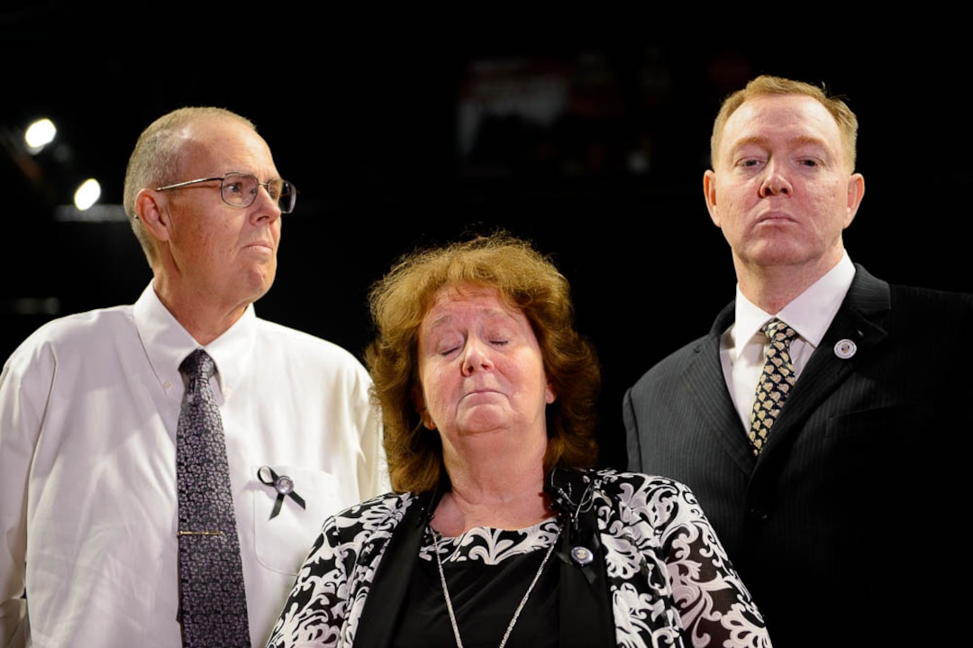 (Trent Nelson | The Salt Lake Tribune)  Julie Egelund reads a statement about her sister Jill Robinson, a West Valley City code-enforcement officer killed on the job last week prior to funeral services at the Maverik Center in West Valley City on Friday Aug. 17, 2018. At left is Julie's husband Kent Egelund, at right her brother Jaren Robinson.