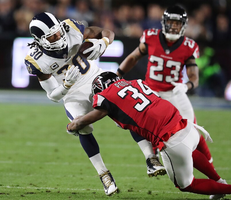 Atlanta Falcons cornerback Brian Poole tackles Los Angeles Rams running back Todd Gurley during the first half of an NFL football wild-card playoff game Saturday, Jan. 6, 2018, in Los Angeles. (Curtis Compton/Atlanta Journal-Constitution via AP)
