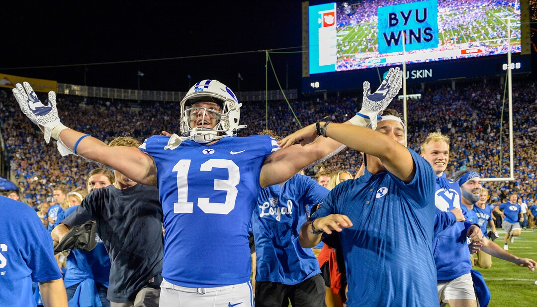 (Chris Samuels | The Salt Lake Tribune) Fans storm the field and celebrate with tight end Masen Wake (13) as the Brigham Young Cougars defeat the Utah Utes 26-17 in football, Saturday, Sept. 11, 2021 in Provo.