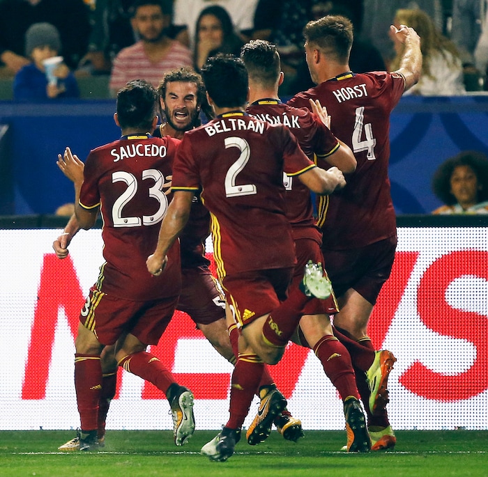 Real Salt Lake midfielder Kyle Beckerman, second from left, celebrates with midfielder Sebastian Saucedo (23), defender Tony Beltran (2), midfielder Albert Rusnak, second from right, and defender David Horst (4) after scoring a goal during the second half of an MLS soccer game against the Los Angeles Galaxy in game in Carson, Calif., Saturday, Sept. 30, 2017. The match ended in a tie. (AP Photo/Alex Gallardo)