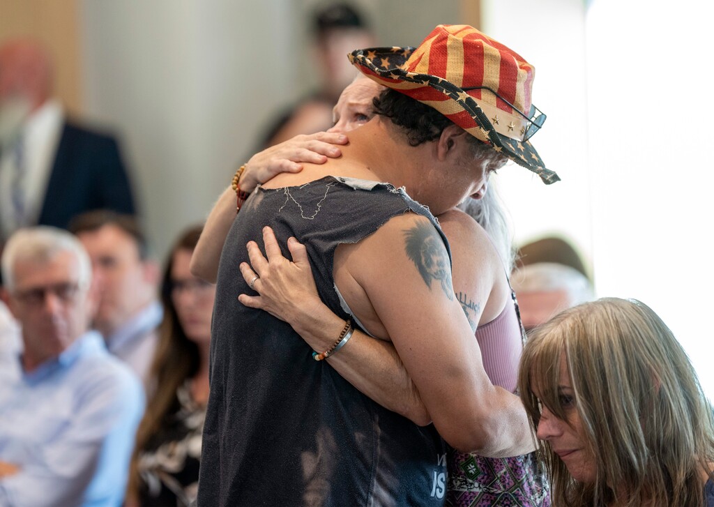 (Rick Egan | The Salt Lake Tribune)  Bonnie Shiffler-Olsen hugs a man who identified himself only as "Chuck" after he spoke about homelessness at the Provo City Council meeting on Tuesday, July 16, 2024. The unhoused have packed into the City Council’s chambers recently to decry a lack of resources and shelter, six years after the city banned camping.