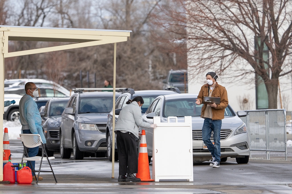 (Leah Hogsten | The Salt Lake Tribune)  Health workers with the Utah Department of Health test the public for COVID-19 at the testing site in the parking lot of the Utah Public Health Laboratory building in Taylorsville Dec. 30, 2021.