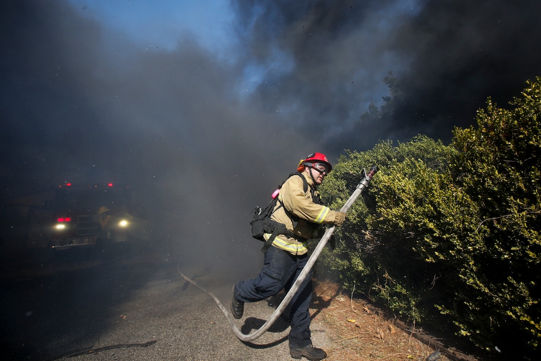 (Ringo H.W. Chiu | AP) A firefighter battles a wildfire near a ranch in Simi Valley, Calif., Wednesday, Oct. 30, 2019.