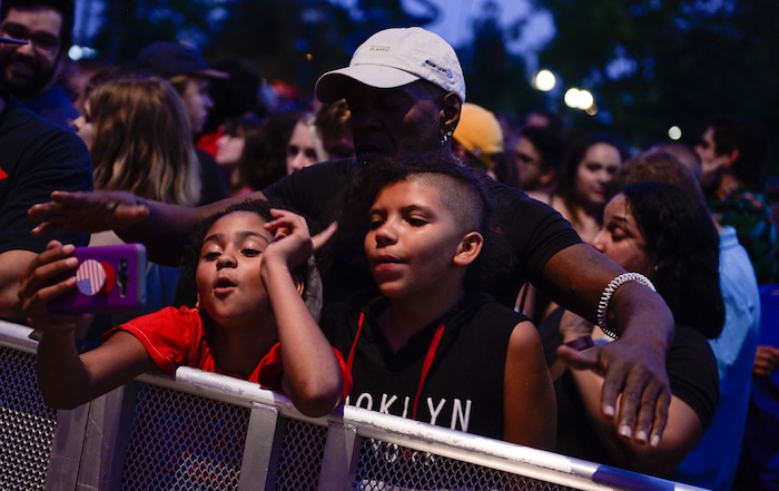 (Francisco Kjolseth | The Salt Lake Tribune) Tyrone Smith is joined by her granddaughter Mya Ruiz, left, and daughter Dakota Reese-Smith as they get ready to enjoy The Roots marking the finale of the 2017 SLC Twilight Concert Series at Pioneer Park on Thursday, Aug. 31, 2017.