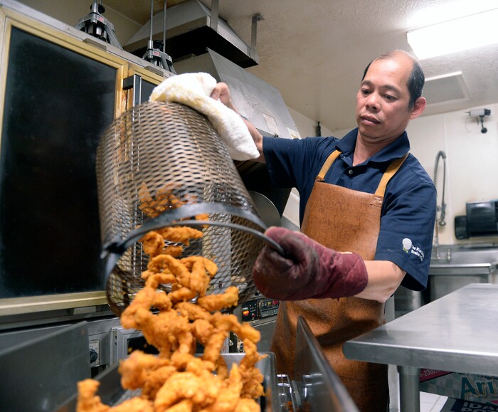 (Al Hartmann | The Salt Lake Tribune) Kevin Nguyen pours out a sizzling batch of crispy fired chicken from his deep-fryer at Kevin's Fried Chicken, located inside the Food Mart/Gas Station at 524 W. 4500 South in Murray.