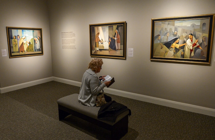 (Leah Hogsten | The Salt Lake Tribune) Myriam Verbauwen, wife of painter Jorge Cocco Santángelo, thumbs through the program detailing her and her husband's history as Argentine Mormons. The Church of Jesus Christ of Latter-day Saints Church History Museum presented two new art exhibits, Thursday, May 17, 2018. Paintings created by Argentine artist Jorge Cocco Santángelo and large-scale images taken by LDS Church staff photographers Cody Bell and Leslie Nilsson will be on display beginning May 17 through Oct. 9, 2018, and January 2019, respectively.